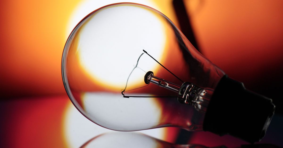 A conceptual image of a light bulb against a vibrant sunset, symbolizing creativity and new ideas.
